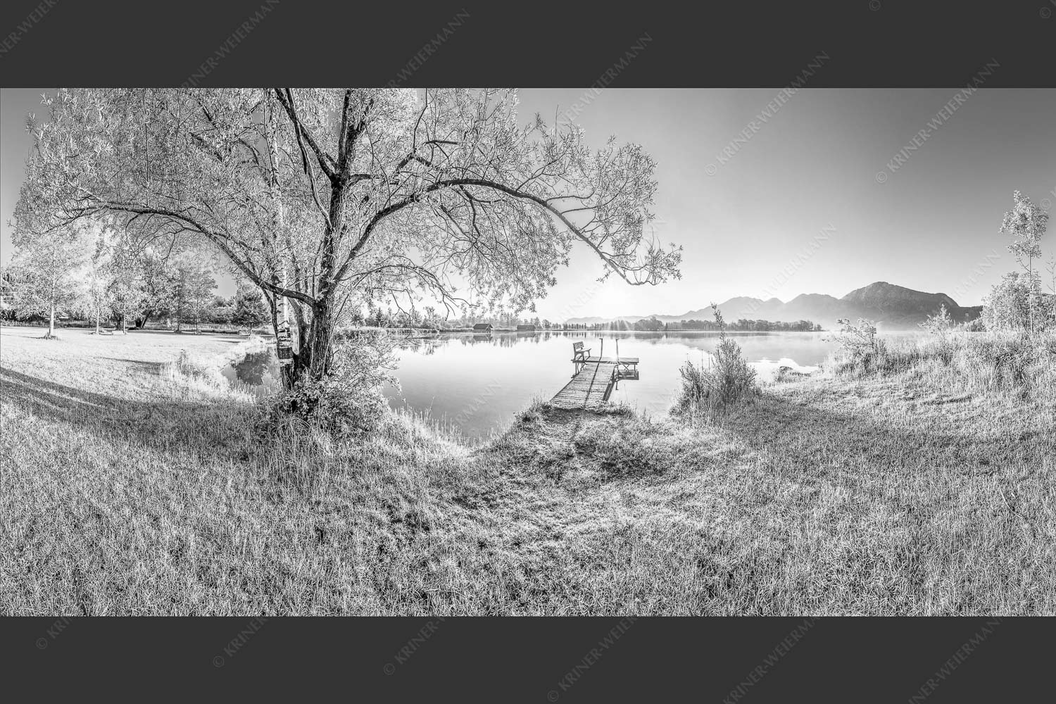 Blick über den Kochelsee bei Schlehdorf in den Sonnenaufgang - Die Sonne geht immer wieder auf III 2:1 sw -- Bootssteg mit Bank am Kochelsee - mehr Infos bei www.Kriner-Weiermann.de