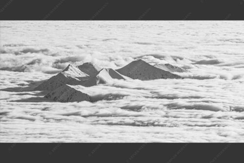 Der Blick von der Zugspitze hinüber zu den verschneiten Gipfeln des Estergebirges - Inselwelten 2:1 sw -- Estergebirge im Nebelmeer - mehr Infos bei www.Kriner-Weiermann.de