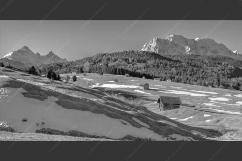 Blick über Buckelwiesen zu den Arnspitzen und Wettersteingebirge - Letzte Reste 2:1 sw -- Heustadel mit Wettersteingebirge - mehr Infos bei www.Kriner-Weiermann.de