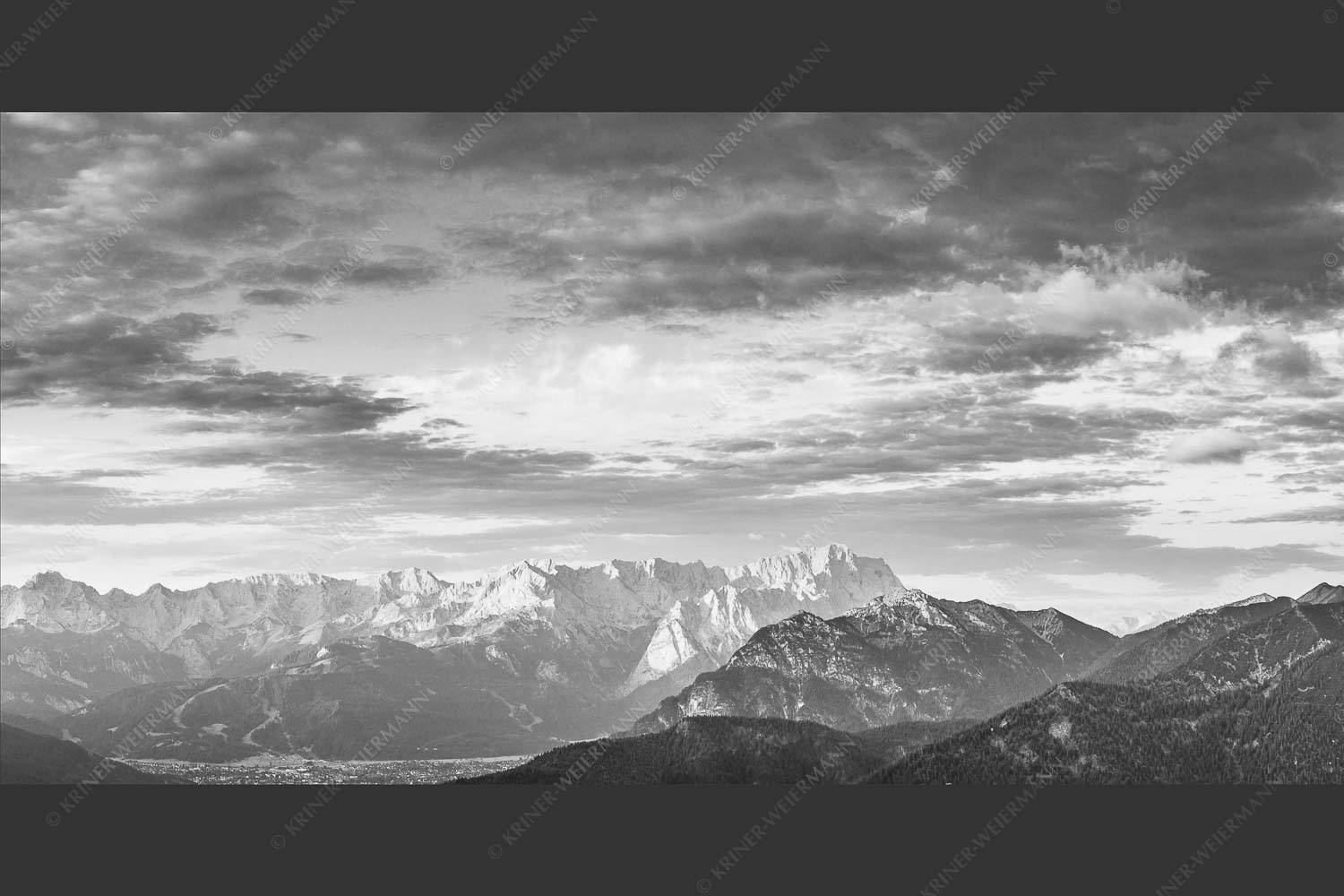Blick über Garmisch-Partenkirchen und Kramer zum Zugspitzmassiv - Der Himmel tut sich auf 2:1 sw -- Garmisch-Partenkirchen mit Wetterstein - mehr Infos bei www.Kriner-Weiermann.de